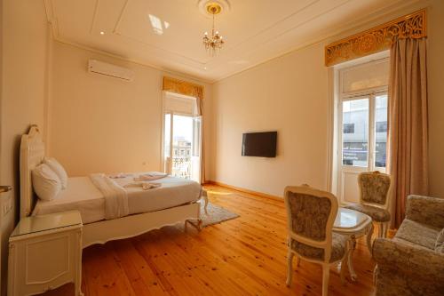 a bedroom with a bed and a living room at Atum in Cairo