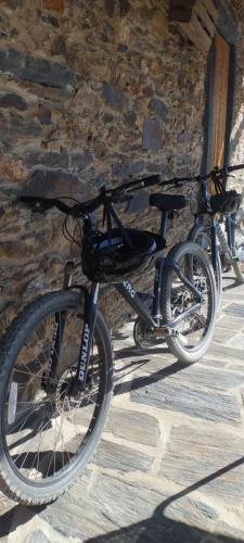 two bikes parked next to a stone wall at Turismo e Alojamento dos Lagos do Sabor - Piscina & SPA in Meirinhos