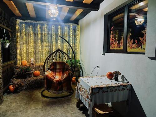 a room with a chair and a table with pumpkins at Карпатський куточок in Slavske