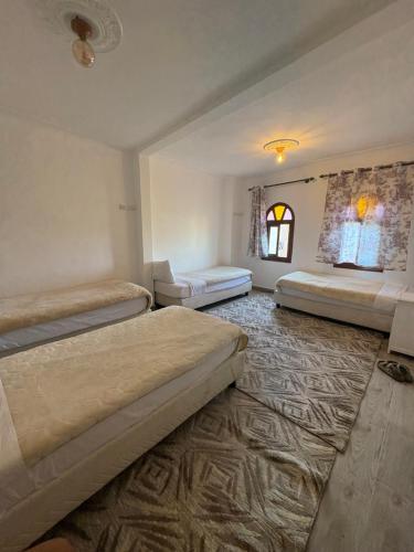 a bedroom with two beds and a rug at Daryussef 114 in Marrakech