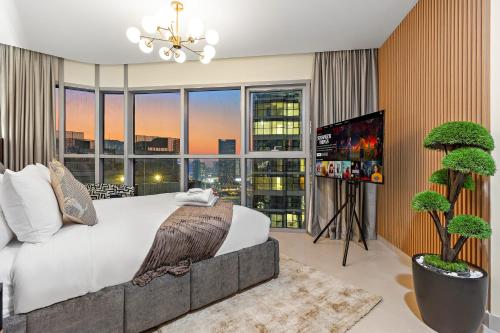 a bedroom with a large bed and a large window at Desert Key Apartments - Al Reem Island in Abu Dhabi