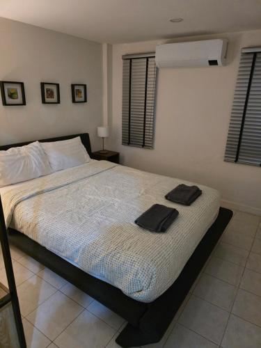 a bedroom with a bed with two towels on it at Pranaluxery Pool Villa 1 in Pran Buri