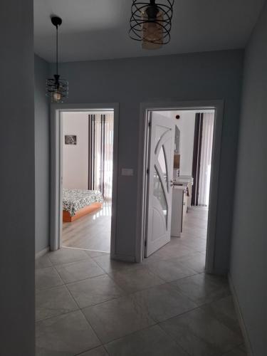 a room with two doors leading to a bedroom at Apartment Active Sport in Pazardzhik