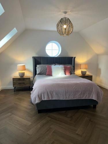a bedroom with a large bed and two night stands at Northampton 3 Bed 3 Bathroom New Duplex Apartment in Spinney Hill