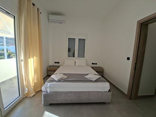 a bedroom with two beds and a large window at Authentic appartement in Aíyira