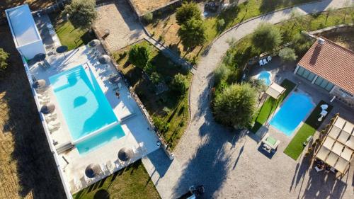 an overhead view of two swimming pools in a yard at Casas Campo Cimo da Quinta in Miranda do Douro