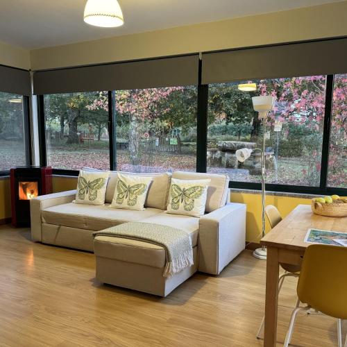 a living room with a couch and a fireplace at Casa Das Palmeiras-Pedagogic Farm in Mangualde