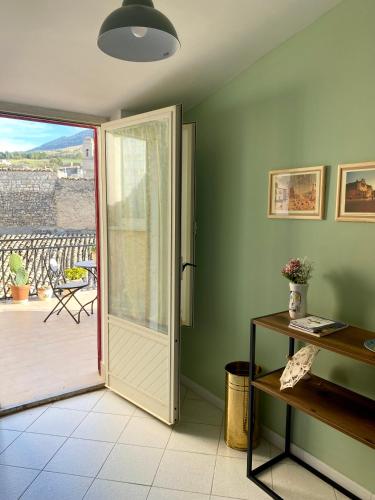 a room with a door leading to a patio at Casetta in piazza in Palazzo Adriano