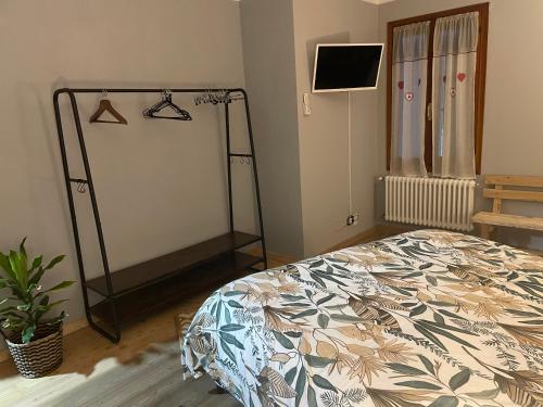 a bedroom with a bed and a television in it at Ca' Dei Sassi in Segusino