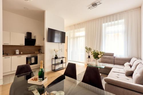 a living room with a couch and a table at Melody Apartments Vienna - Modern & Spacious with Terrace in Vienna
