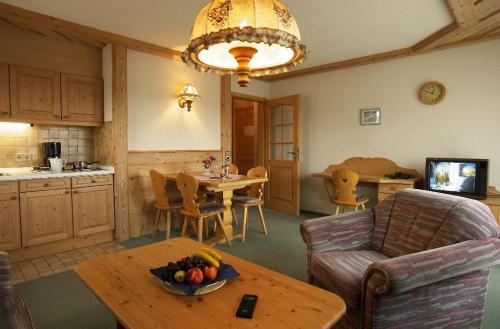 a living room with a table with a bowl of fruit at Landgasthof Löwen in Neubulach