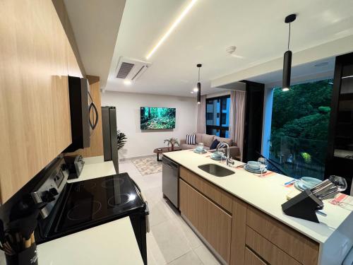 a kitchen with a sink and a counter top at Vistas del Bosque Jacó in Jacó