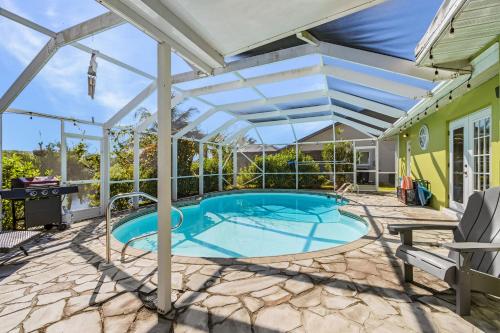 a pergola over a swimming pool on a house at Coral Canal Cove in Cape Coral