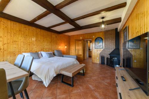 a bedroom with a bed and a fireplace at Chalet Copos Nevados by Surynieve in Sierra Nevada