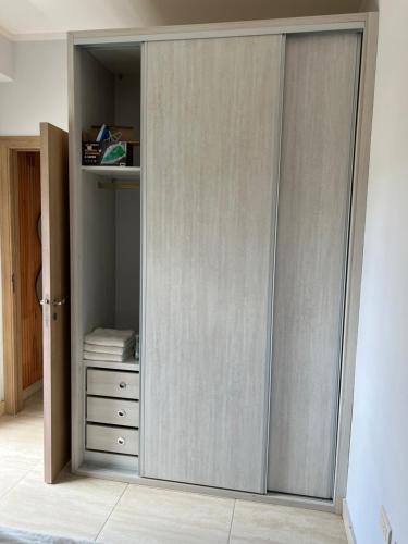 a closet with sliding doors in a room at Departamento amoblado centro capital in San Juan