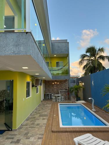 a house with a swimming pool and a balcony at WT Corais Flats in Maragogi