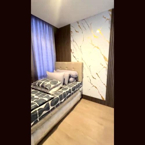 a bedroom with a bed with pillows on it at 31 Sudirman Suites in Makassar