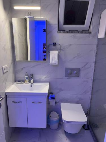 a bathroom with a sink and a toilet and a mirror at Barış Apart in Dalaman
