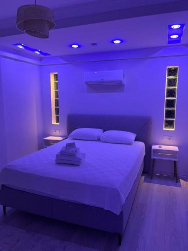 a purple bedroom with a bed and two night stands at Barış Apart in Dalaman