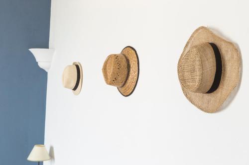 a pair of straw hats hanging on a wall at Relais Regina Giovanna in Sorrento