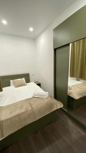 a bedroom with a bed and a large mirror at My Apartment in Kvareli