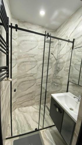 a bathroom with a shower and a sink at My Apartment in Kvareli