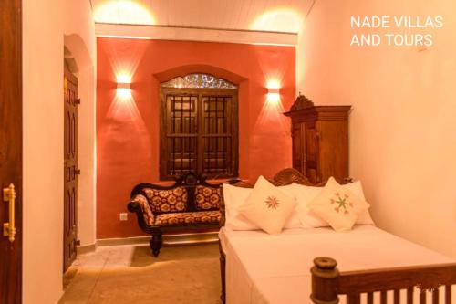 a bedroom with a bed and a chair in a room at Nade Villas Madu River Rest in Balapitiya