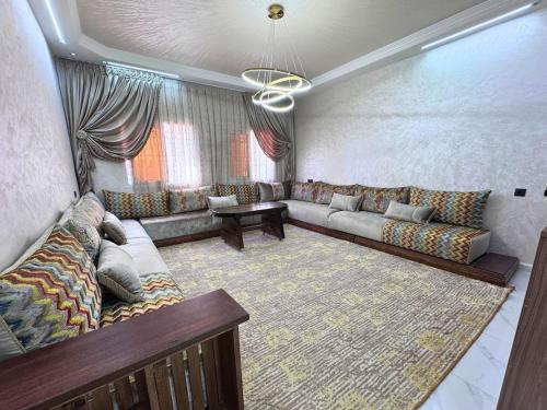 a living room with a couch and a table at Le Nid d'Essaouira in Essaouira