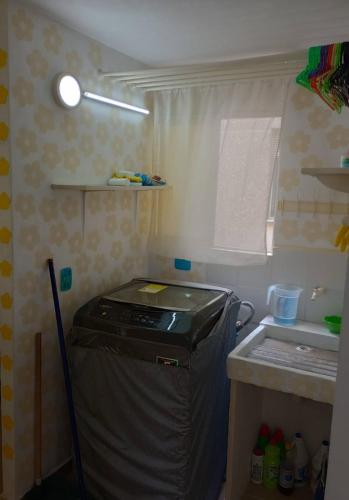 a small kitchen with a stove and a sink at Deluxury in Santa Marta