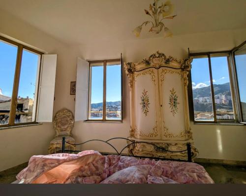 a bedroom with two beds in a room with windows at Casa Abenante in Corigliano Calabro