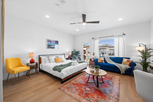 a bedroom with a bed and a couch and a table at Stylish Top-Floor Gem with King Bed & City Ocean Views in San Diego