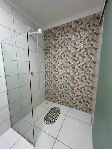 a bathroom with a shower with a glass door at WT Corais Flats in Maragogi