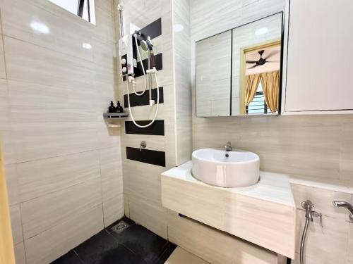 a bathroom with a sink and a mirror at D'Summit Suite by Luxecocoo CK Kempas Setia Tropika in Kempas