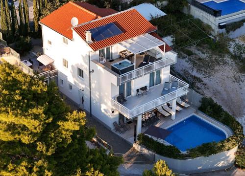 an aerial view of a house with a swimming pool at Villa ELLA ESTELLE with a heated pool, hot tub, sauna in Mimice
