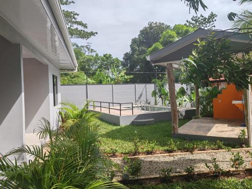 a backyard of a house with a deck and a fence at Casa Conga in Puerto Limón