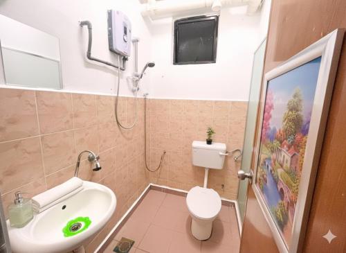 a bathroom with a sink and a toilet and a shower at Cozy Stay ANJANA SERI GUEST HOUSE HOMESTAY Melaka in Ayer Keroh