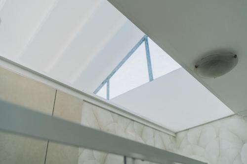 a room with a glass ceiling with a light at Ihita unit 11 in Sandton