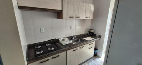 a kitchen with a sink and a counter top at MM Apart Premium Joinville in Joinville