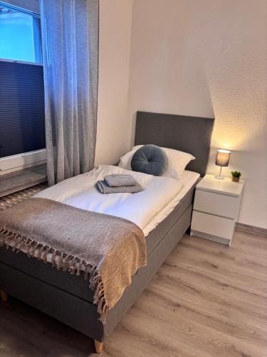a bedroom with a large bed with a window at Apartment-Topnik Datteln in Datteln