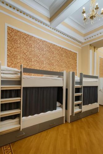 a room with three bunk beds in it at Veluna Inn Hostel & Hotel in Baku