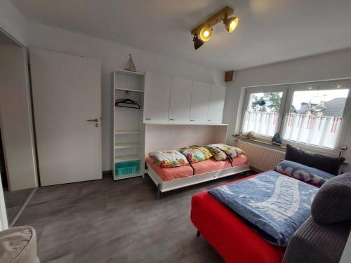 a bedroom with a bed and a couch and a window at Fewo Erdgeschoss Ankerplatz mit Sauna direkt am Brombachsee bei Juliane und Klaus in Ramsberg