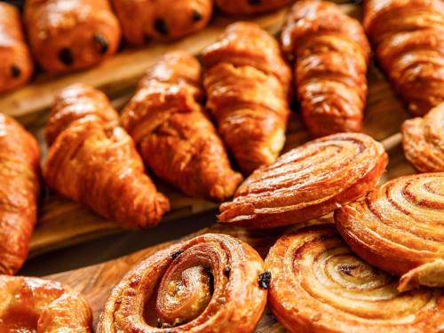 a bunch of pastries and croissants on a table at Mercure Paignton Hotel in Paignton