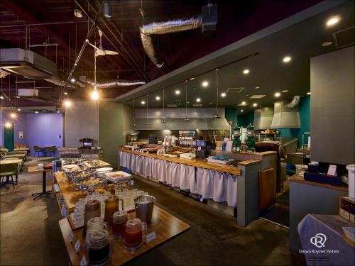 a restaurant with a buffet line with food on tables at Daiwa Roynet Utsunomiya in Utsunomiya