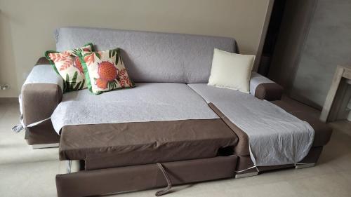 a couch with pillows on it in a room at Marea in Mola di Bari