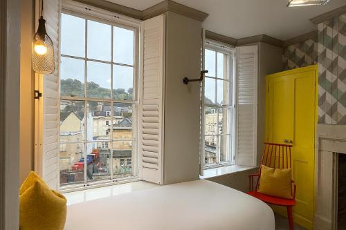 a bedroom with a bed and a window with a view at Dream Stays Bath - Beau Street Apartments in Bath