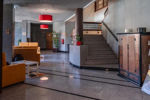 a lobby with a staircase in a building at Douro Marina Hotel & SPA in Resende
