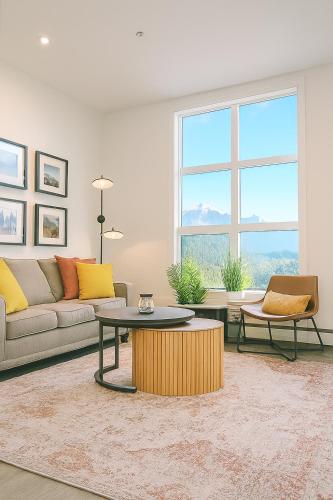 a living room with a couch and a table at New Vaulted Ceilings 3 Beds AC Views in Golden