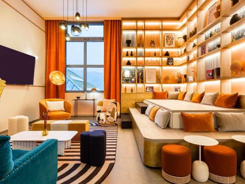 a hotel room with two beds and a couch at Le Saint Gervais Hotel & Spa Handwritten Collection in Saint-Gervais-les-Bains