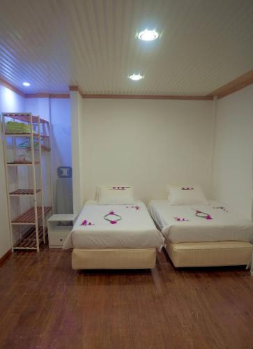 a room with two beds and a ladder at AHI Maldives in Omadhoo