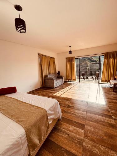 a bedroom with a bed and a view of a patio at Hotel Alma Verde in Chiquinquirá